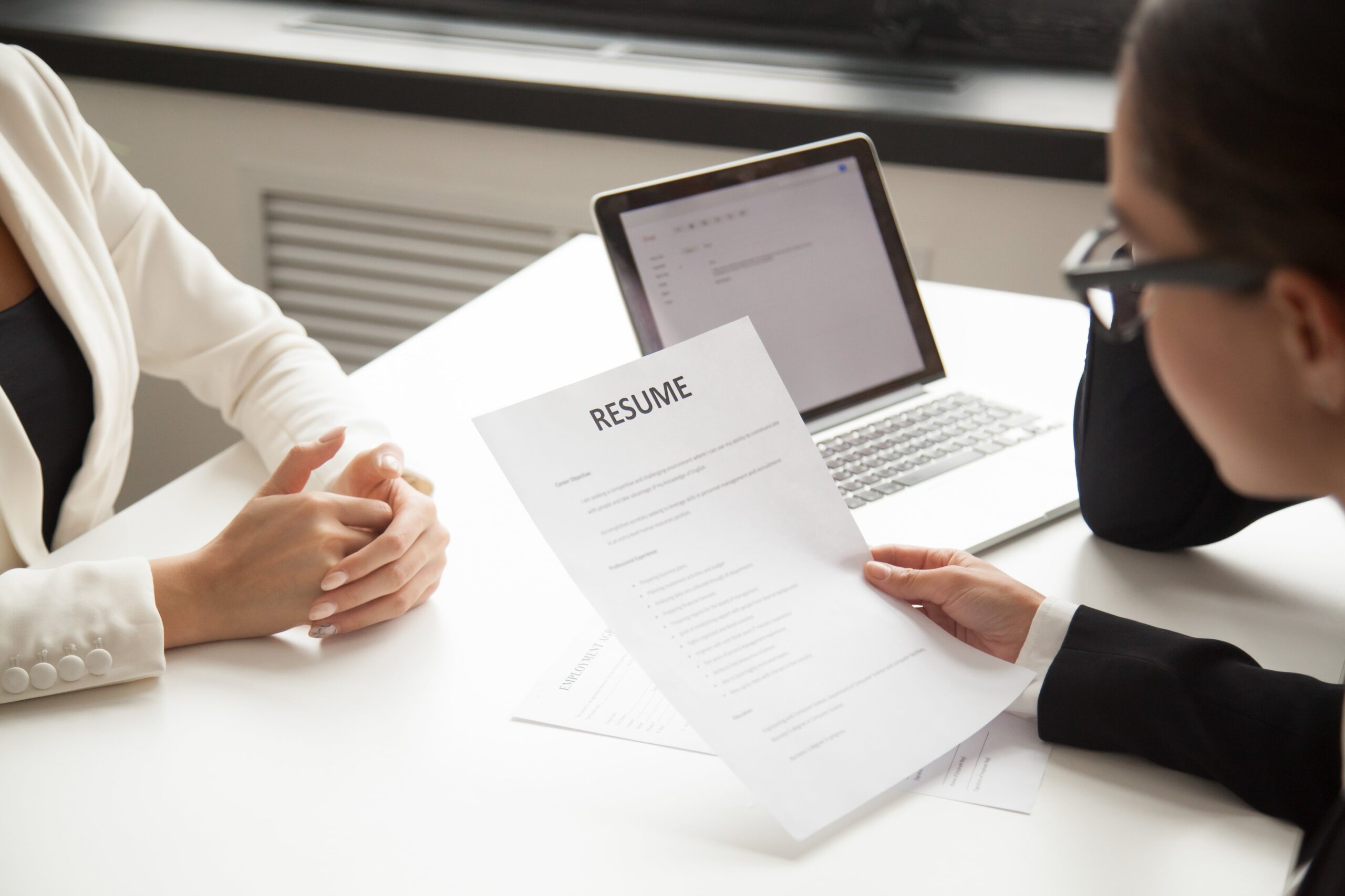 company-representatives-reading-applicant-resume-hiring-min (1)